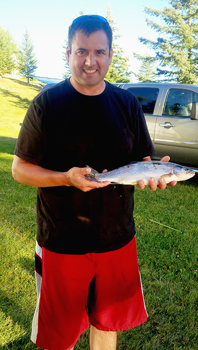 Andy Fochuk of Fort St. John caught his first Lac des Roches rainbow trout in August, during the time of year when fishing can be very challenging. — image credit: Allison Fochuk