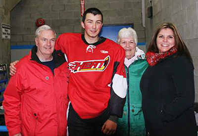 Proud uncle Harold Edwards, left, posed with family members Trevor Okino of the Chase Heat, Lynn Turner and Stacey Okino at the Nov. 27 hockey game against the 100 Mile House Wranglers. — image credit: Submitted photo